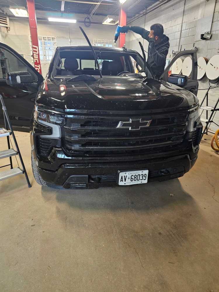 Auto Glass Repair and Replacement technician working on a windshield